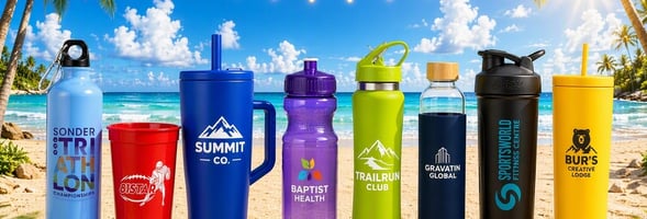 Eight branded promotional drinkware styles lined up on a sunny beach with palm trees, string lights, and turquoise ocean.